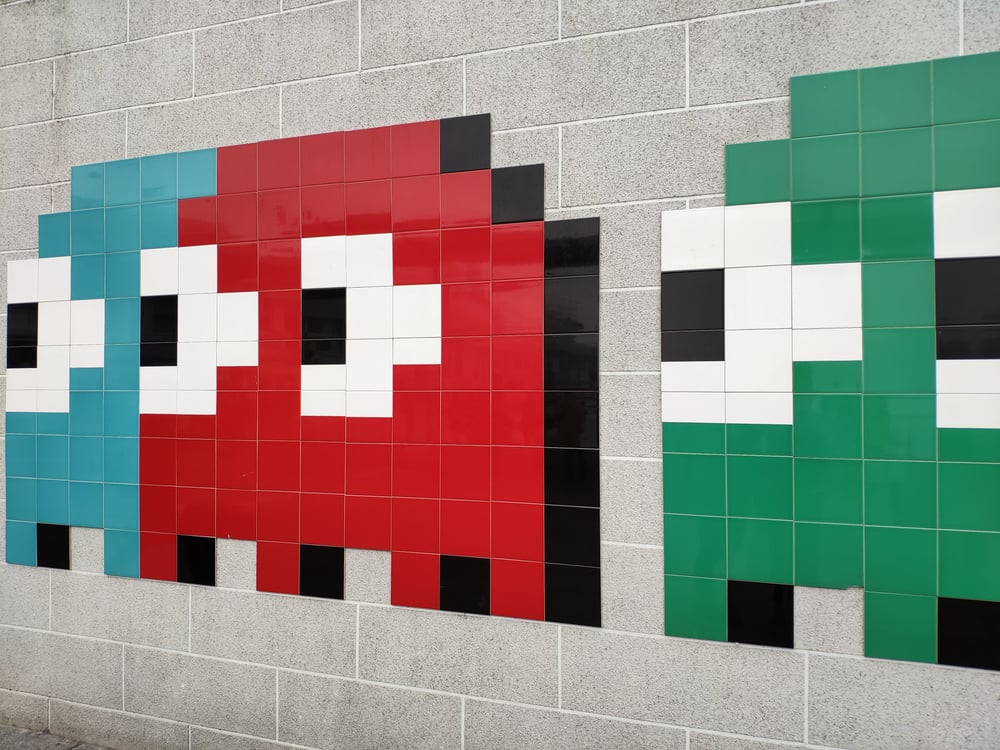 Pacman monsters on a grey wall